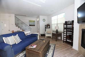 Living area with stairs leading the the bedrooms on the second level.