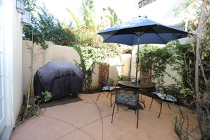 Patio with grill. French doors in the living area lead to the patio.
