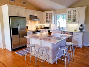 Remodeled Kitchen with Carrara Marble Countertops and Farmhouse Sink