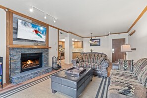 Living room with Stacked slate Fireplace and Smart TV mounted above
