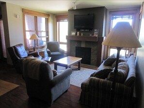 Living Room area with Flat Panel TV and Swivel Rocker Recliner.