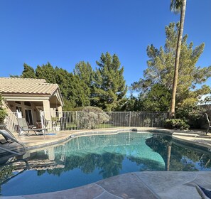 Pool and yard separated by fence.