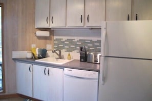 Newly remodeled kitchen with brand new silverware, plates, pans, knives....etc!