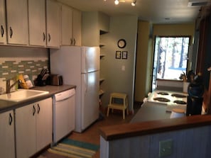 Roomy, modern kitchen with brand new counters, fixtures, pans, knives, dishes...