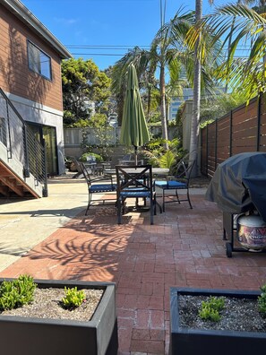 Backyard patio with dining area and gas bbq