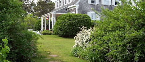 A flagstone walkway from the parking lot up to the house