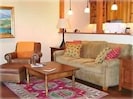 Leather chair & ottoman, cozy overstuffed sofa, hardwood floors & handmade rugs