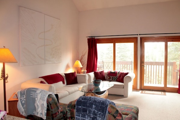 Our cozy living room offers views to the forested wetlands just outside.