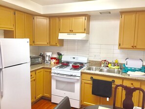 Full kitchen with gas stove/oven, toaster oven, microwave, coffee maker, fridge