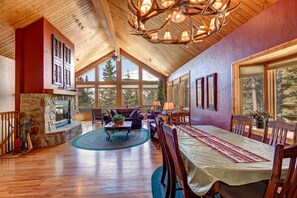 The living room is open and highlighted by a wall of windows.