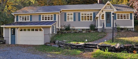 Older photo showing house in early fall, before walls & driveway redone.

