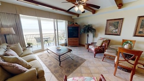 Comfortable, spacious living room with queen sleeper sofa, TV/DVD, and balcony access