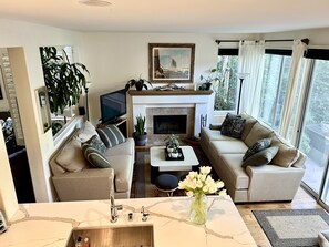 Family room with working fireplace. View from kitchen.
