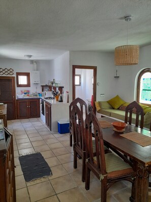 View from the dining room to the kitchen showing the downstairs bathroom.



