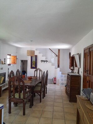 View from  the kitchen to the dining room with stairs up to first floor.