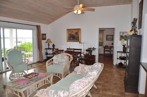  Living room, 12 foot sliding doors for sea view.  Comfortable furniture. Dining table for 6.  Large front room design separates bedrooms for privacy.