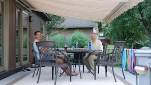 Outdoor dinning with retractable awning