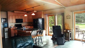 Kitchen opens to sliding glass door to outdoor dinning. Also eat-in bar