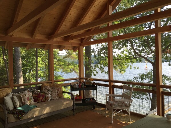 Screened porch with soft night lighting for evening  meals, day bed for naps!