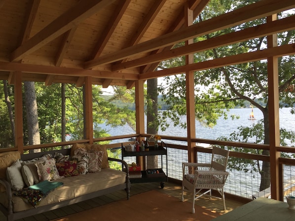 Screened porch with soft night lighting for evening meals, day bed for naps!