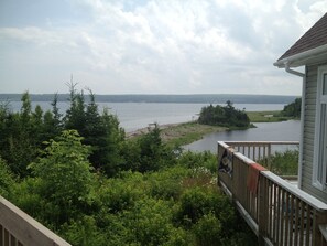 Side deck of beach house and you can see lagoon and beach