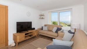 Lounge with leather sofas and 43" smart TV.