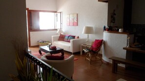 Living room (with door to terrace on left) from top of stairs down to bedrooms.