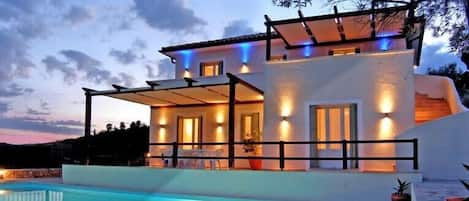 Nightime view of pool and villa