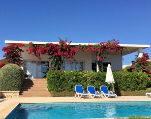 Front view of our villa, lounge and covered terrace, steps down to private pool.