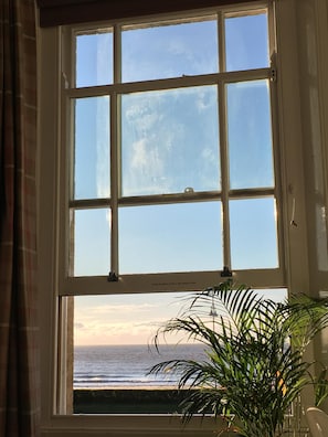 view of the sea from the double bedroom with our tall elegant window open.