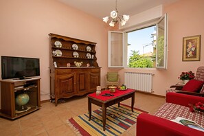 Living room with flat-screen TV and views of the garden