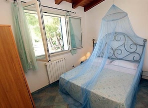 The second cozy bedroom of the villa also with a view of the sea.