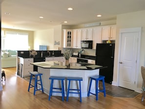 Open kitchen with counter and barstool seating
