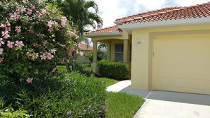 Walking into the front door from the driveway.