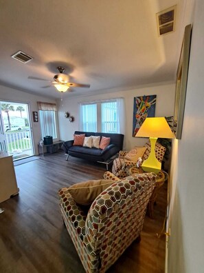 Living room new flooring and a new leather futon with charging ports. June 2021 