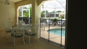 Lanai and Pool view from Kitchen/Family Room. Pool safety fence available.