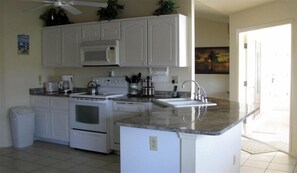 Eat in Kitchen opens onto Lanai and Pool. All kitchenware is provided.