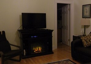 Flat screen TV with cozy electric fireplace.