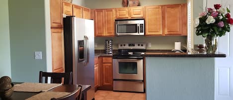 Granite counters in kitchen. Frig with water and ice.