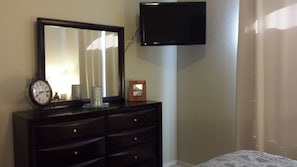 Mounted TV with channels in bedroom