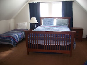 Upstairs bedroom with queen bed and two twin beds
