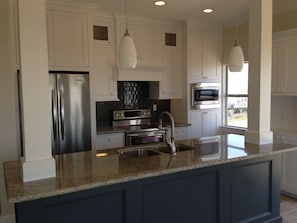 Kitchen - stainless appliances, granite island.  You bring groceries + the cook!