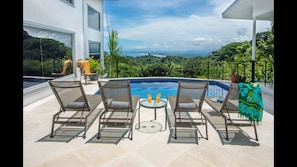 The pool area has an amazing ocean view