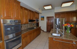 Kitchen with double oven view and granite counter tops