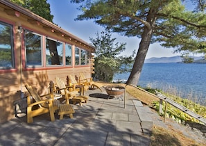 Patio with grill and fire pit overlooking Lake George, with view to north