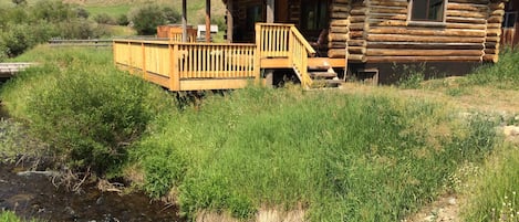 creek cabin front two tier deck to creek alongside the ranch driveway