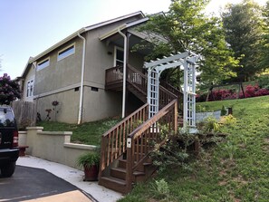 Parking for one vehicle by stairs going up to apartment 