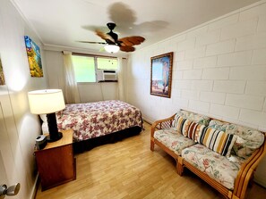 Queen bed, ceiling fan, Window AC, sitting couch