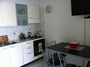 Dining area. Wall mounted TV and DVD.
