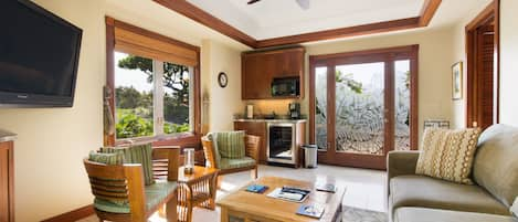 The guest house sitting room features a wet bar, TV and a queen pull-out sofa.